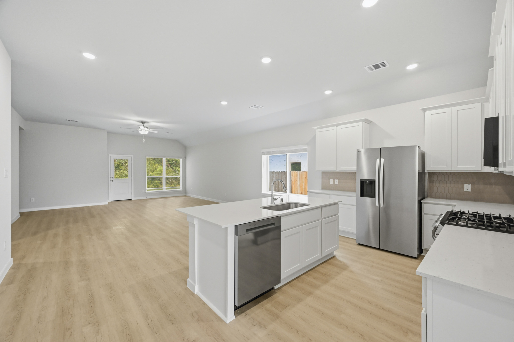 A kitchen with white cabinets.