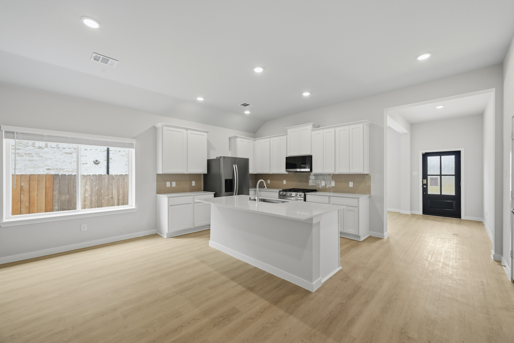 A kitchen with white cabinets.