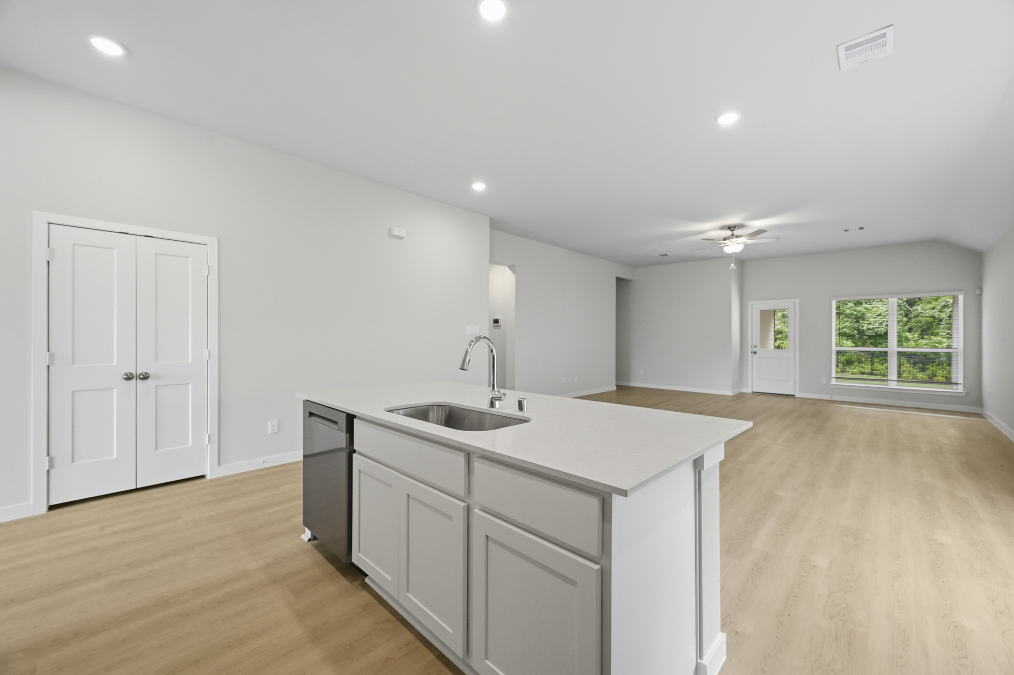 A kitchen with white cabinets.