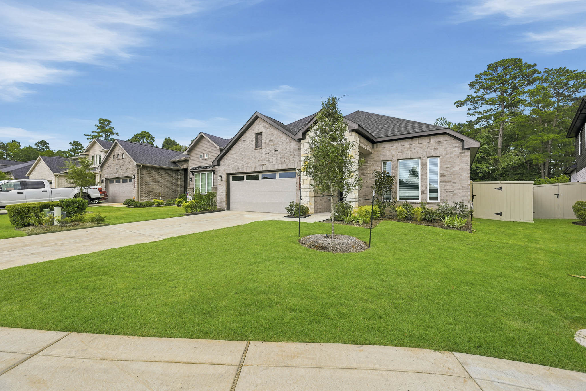 A house with a large yard with Chavenage House in the background.