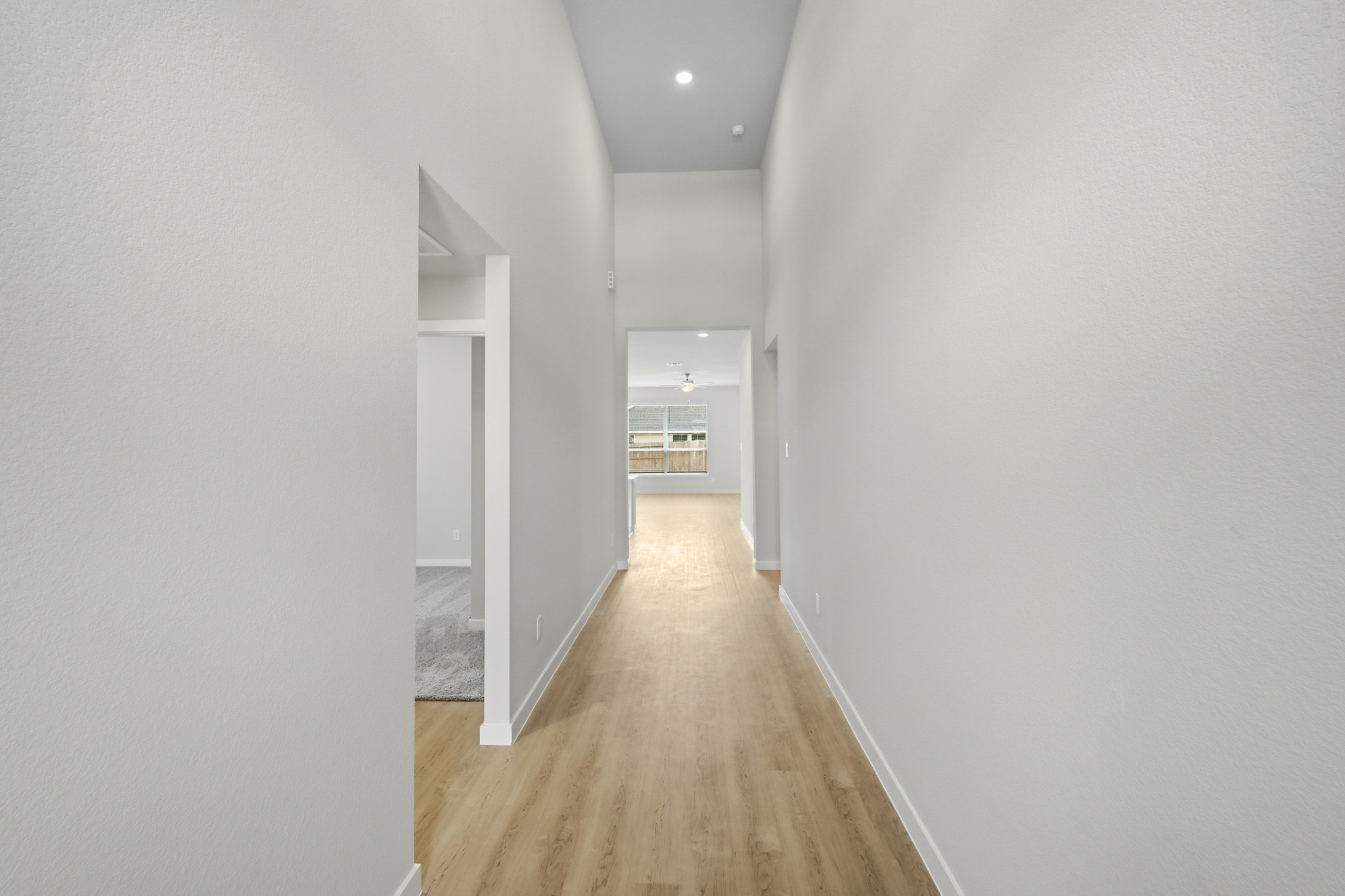 A hallway with white walls.
