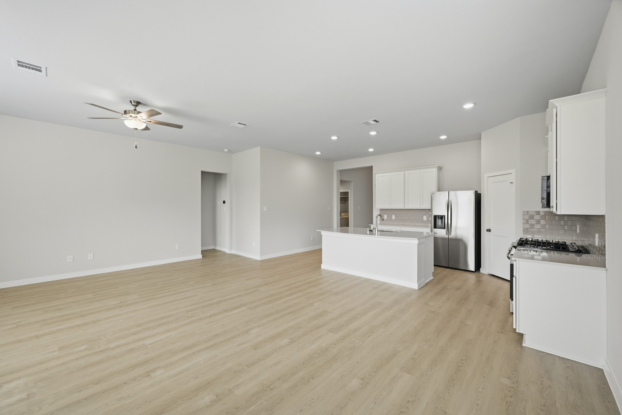A kitchen with white cabinets.