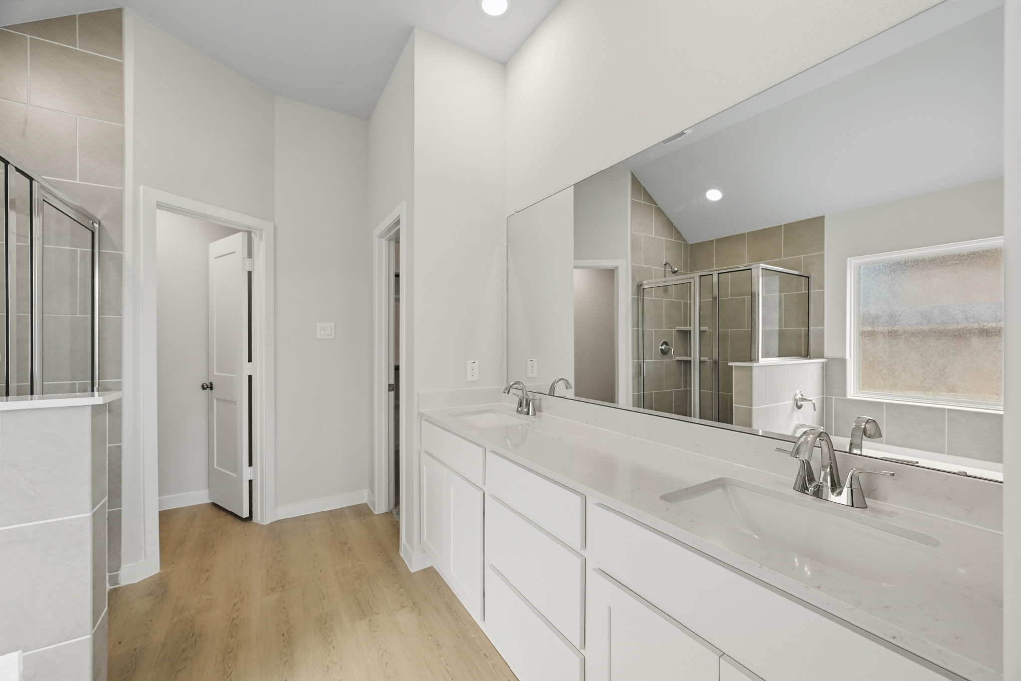 A bathroom with white cabinets.