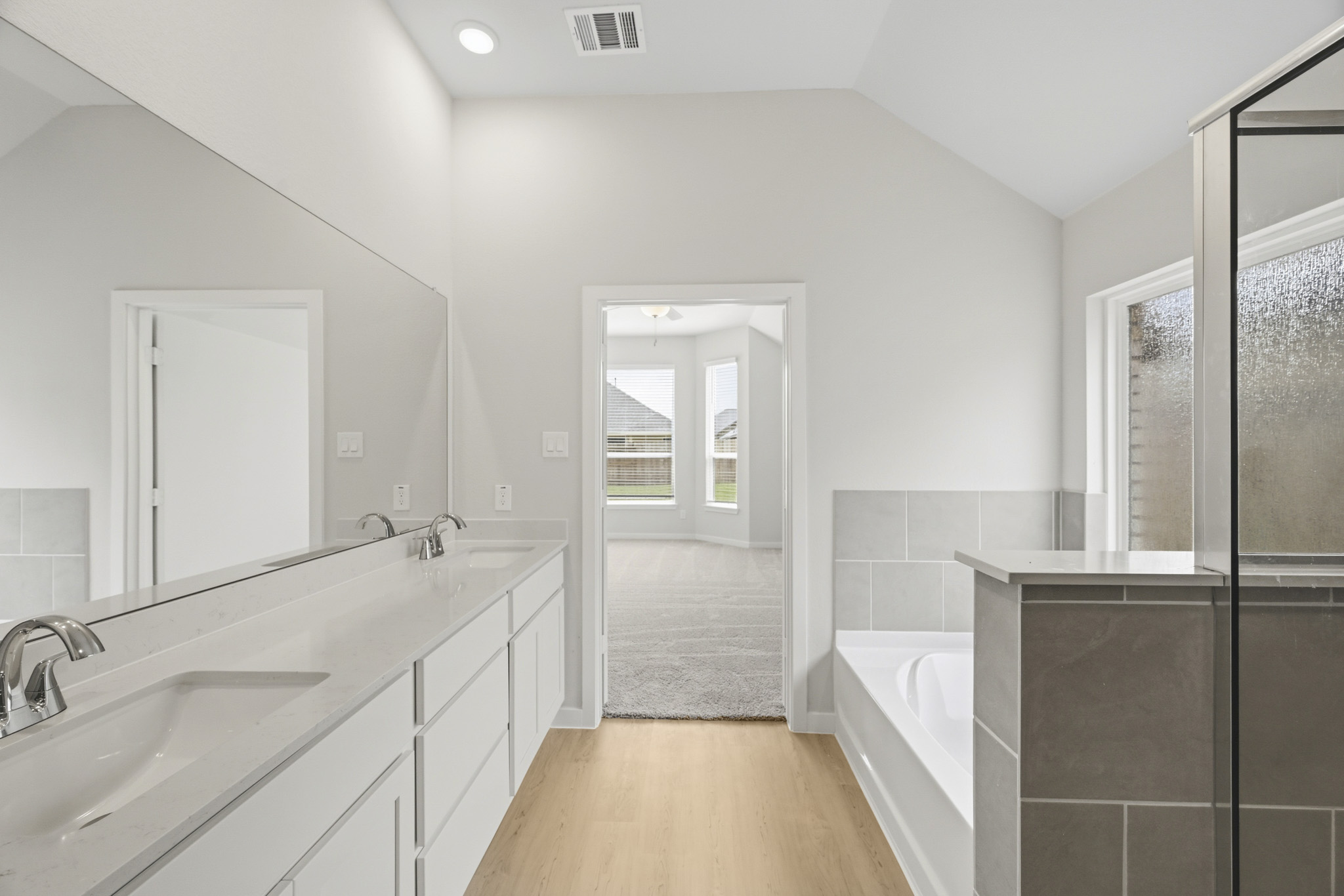 A bathroom with a tub sink and a shower.