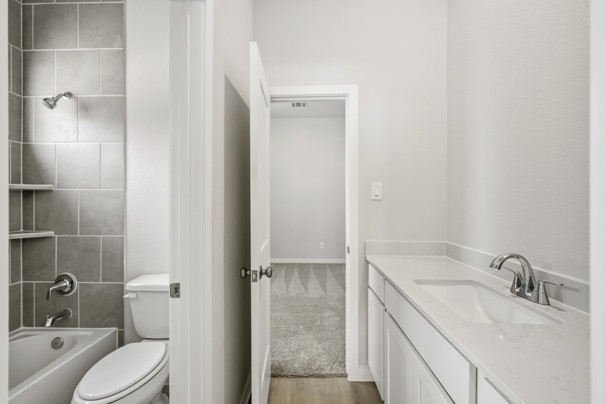 A bathroom with a toilet sink and a shower.