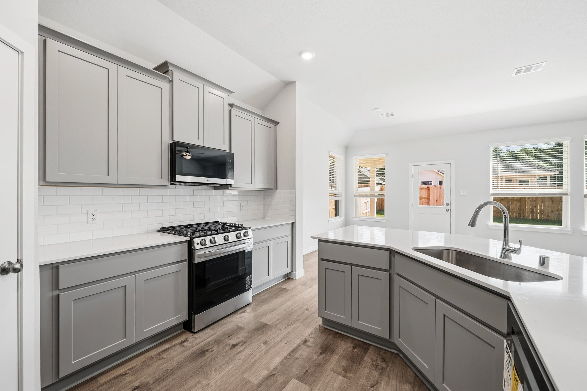 A kitchen with white cabinets.
