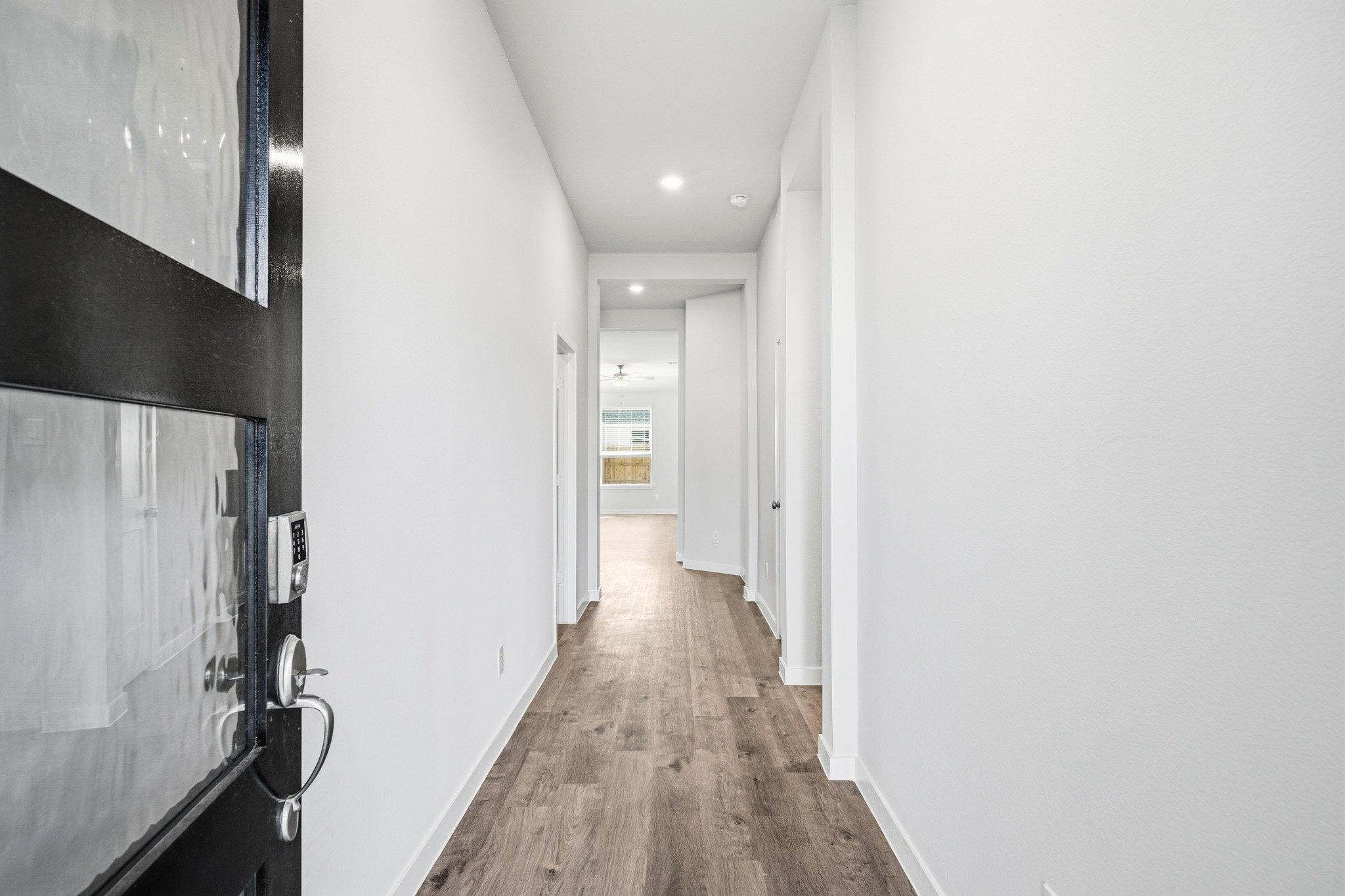 A hallway with white walls.