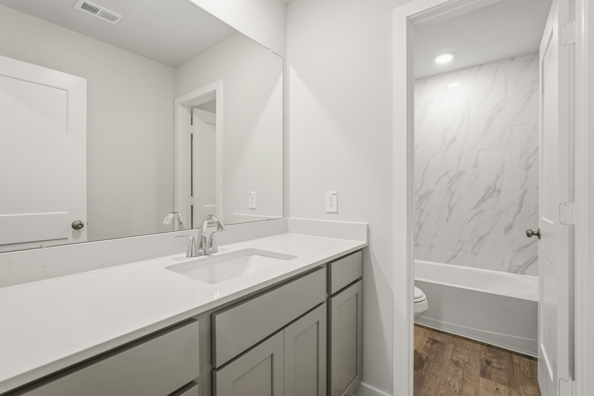 A bathroom with a sink and a bathtub.