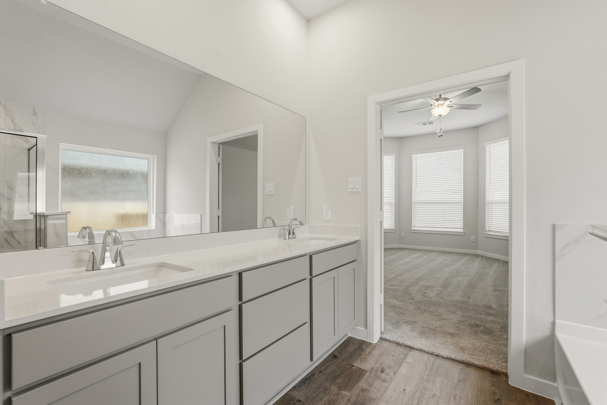 A bathroom with a large mirror.