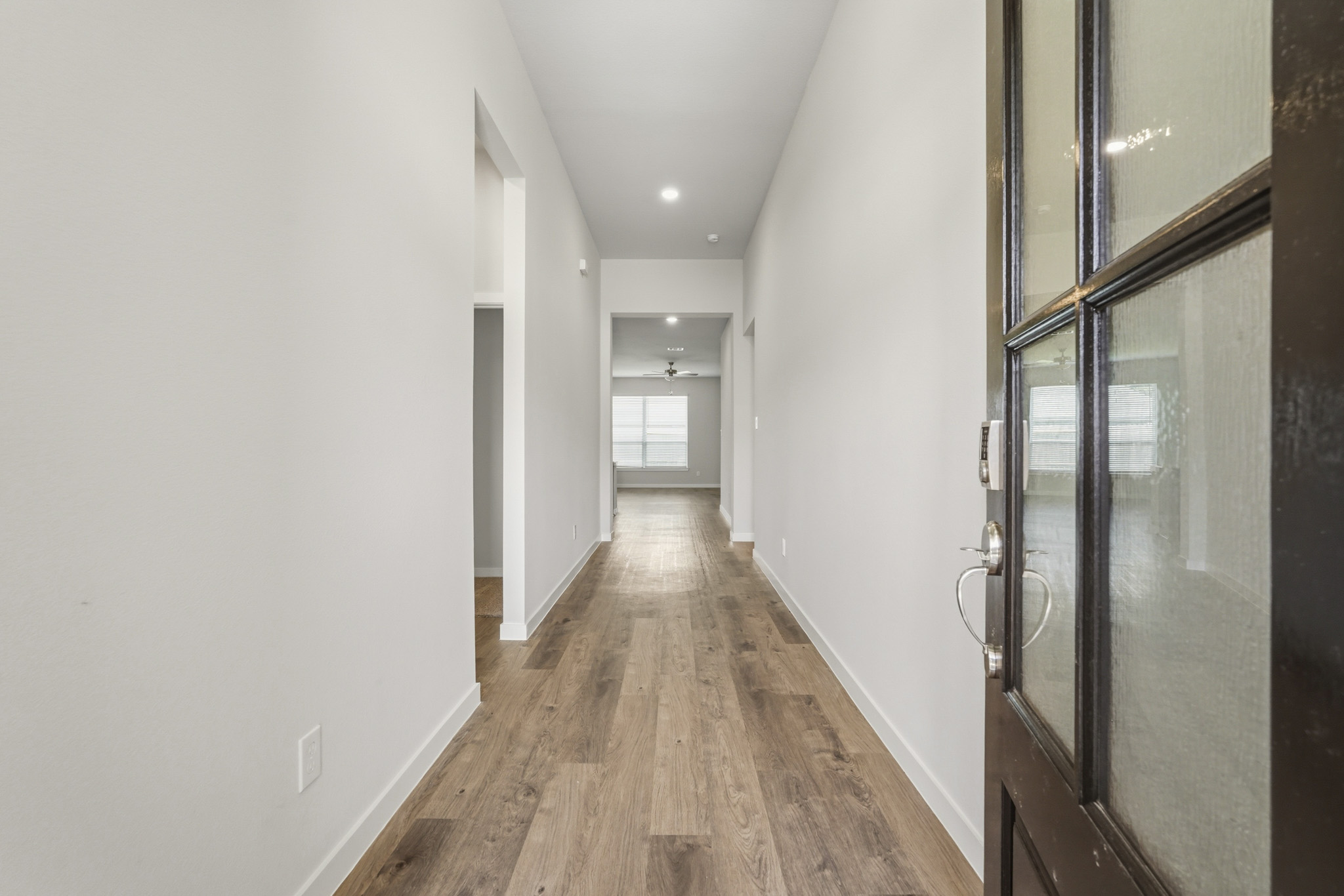 A hallway with glass doors.