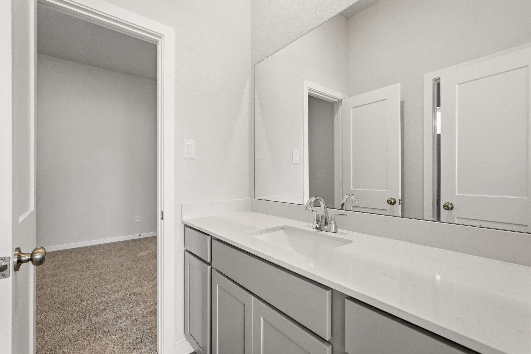 A bathroom with a sink and cabinets.