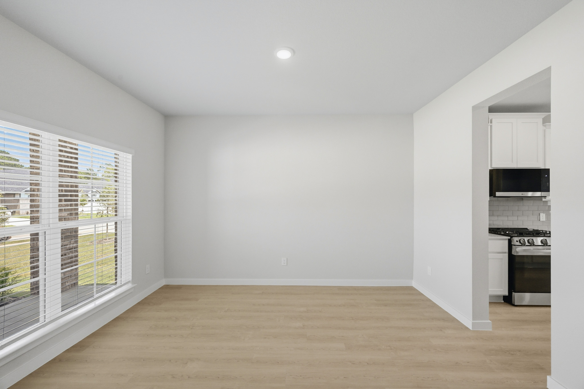 A room with a wood floor and a window.