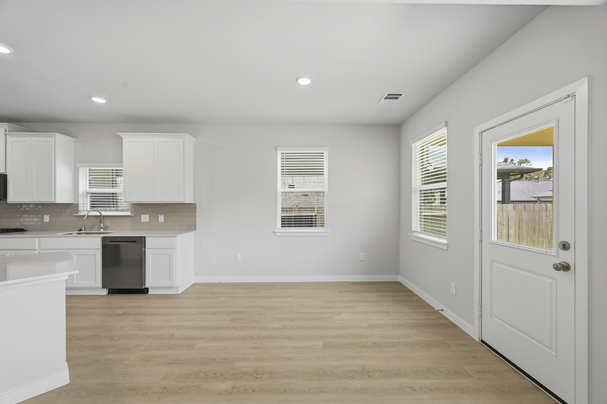 A kitchen with white cabinets.