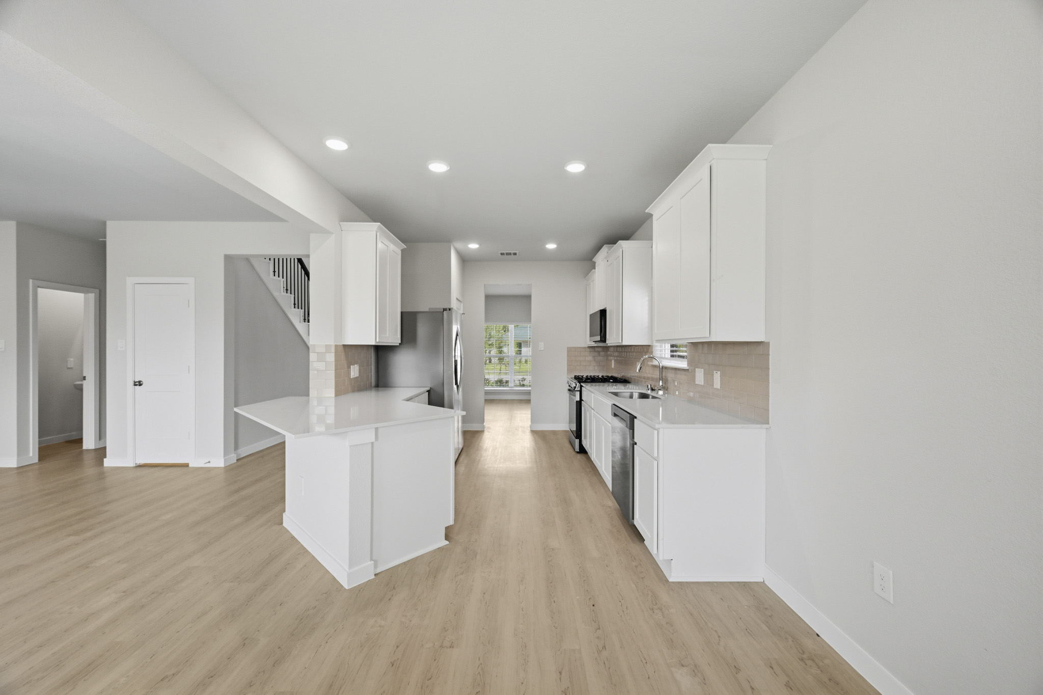 A kitchen with white cabinets.