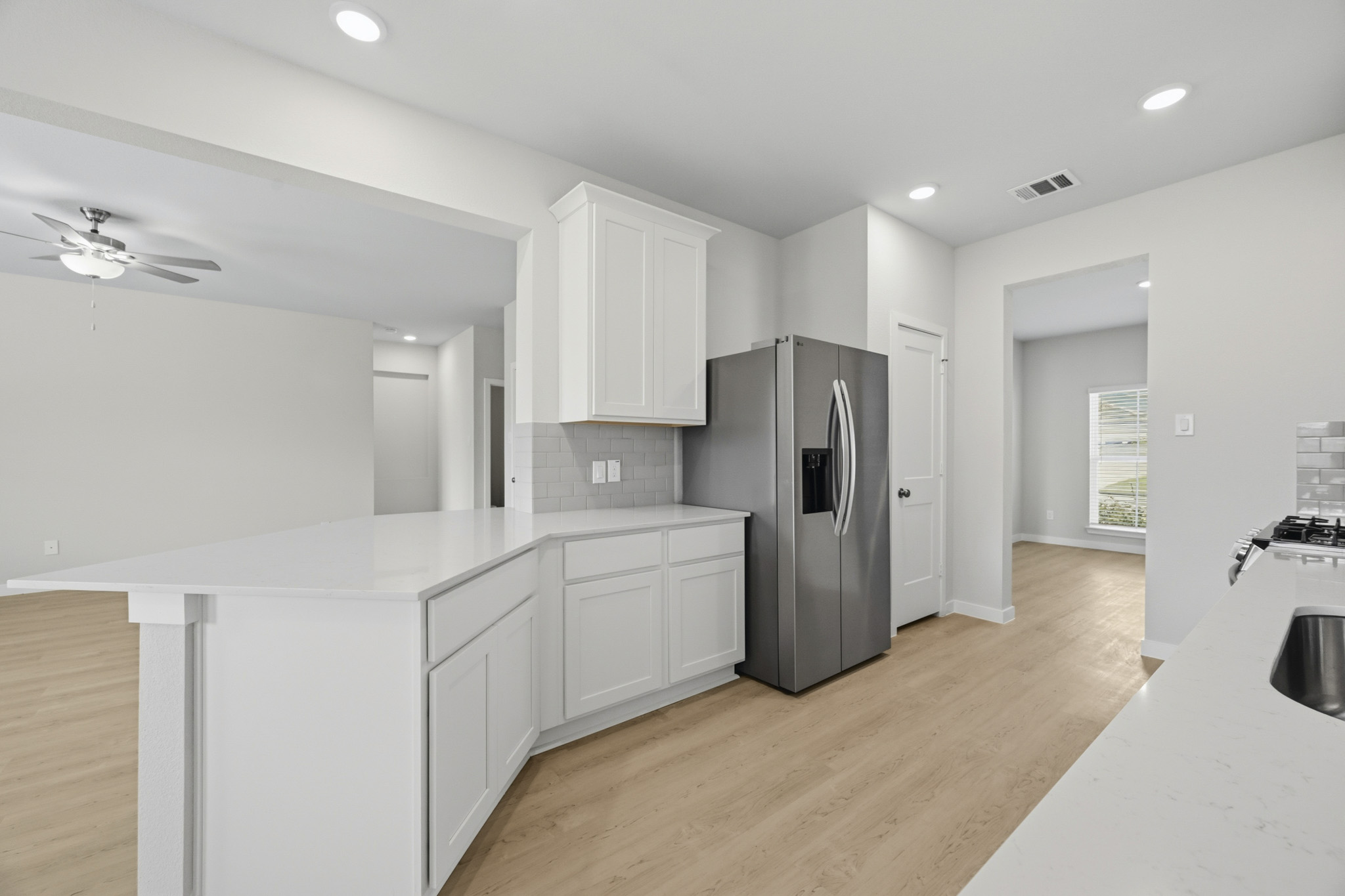A kitchen with white cabinets.