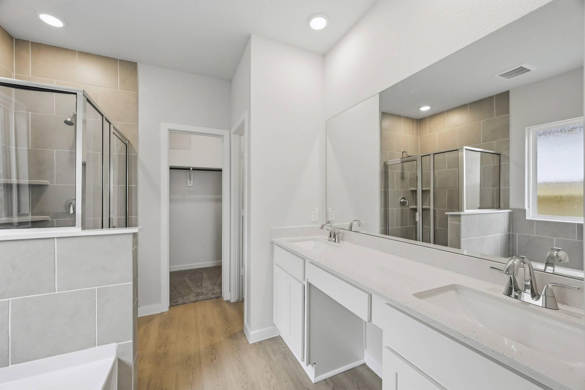 A bathroom with a large mirror.