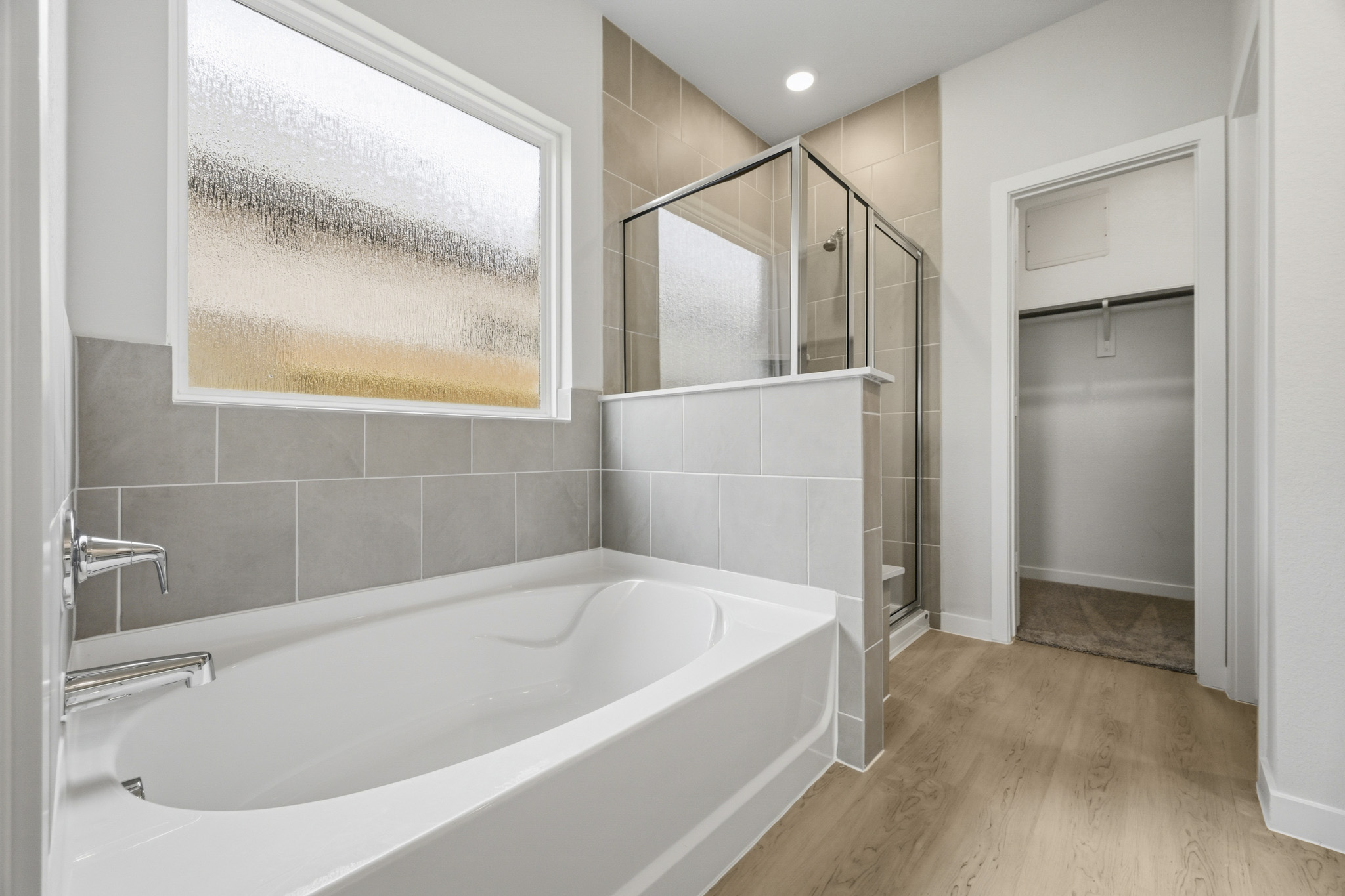 A bathroom with a tub and shower.