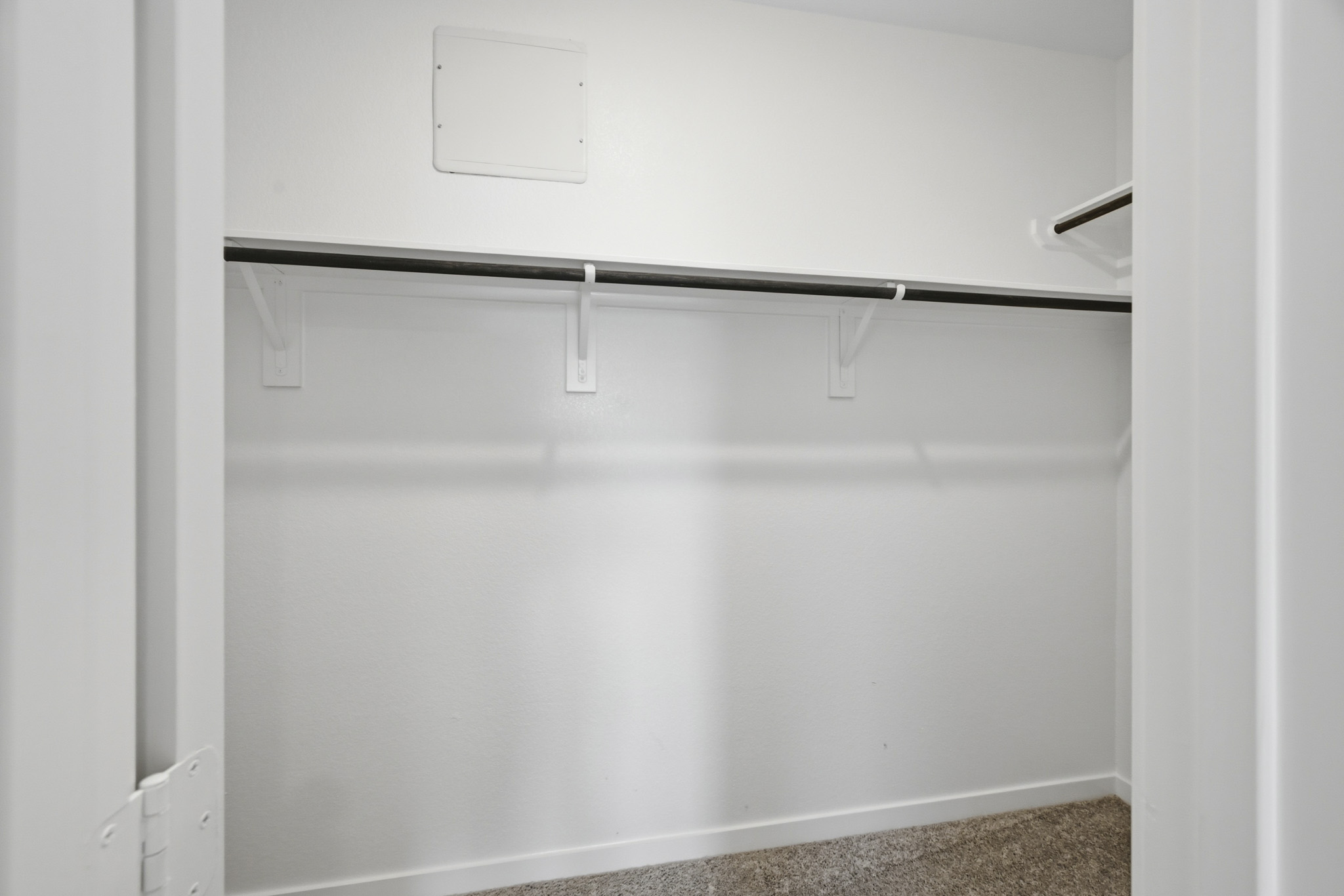 A white wall with a black bar.