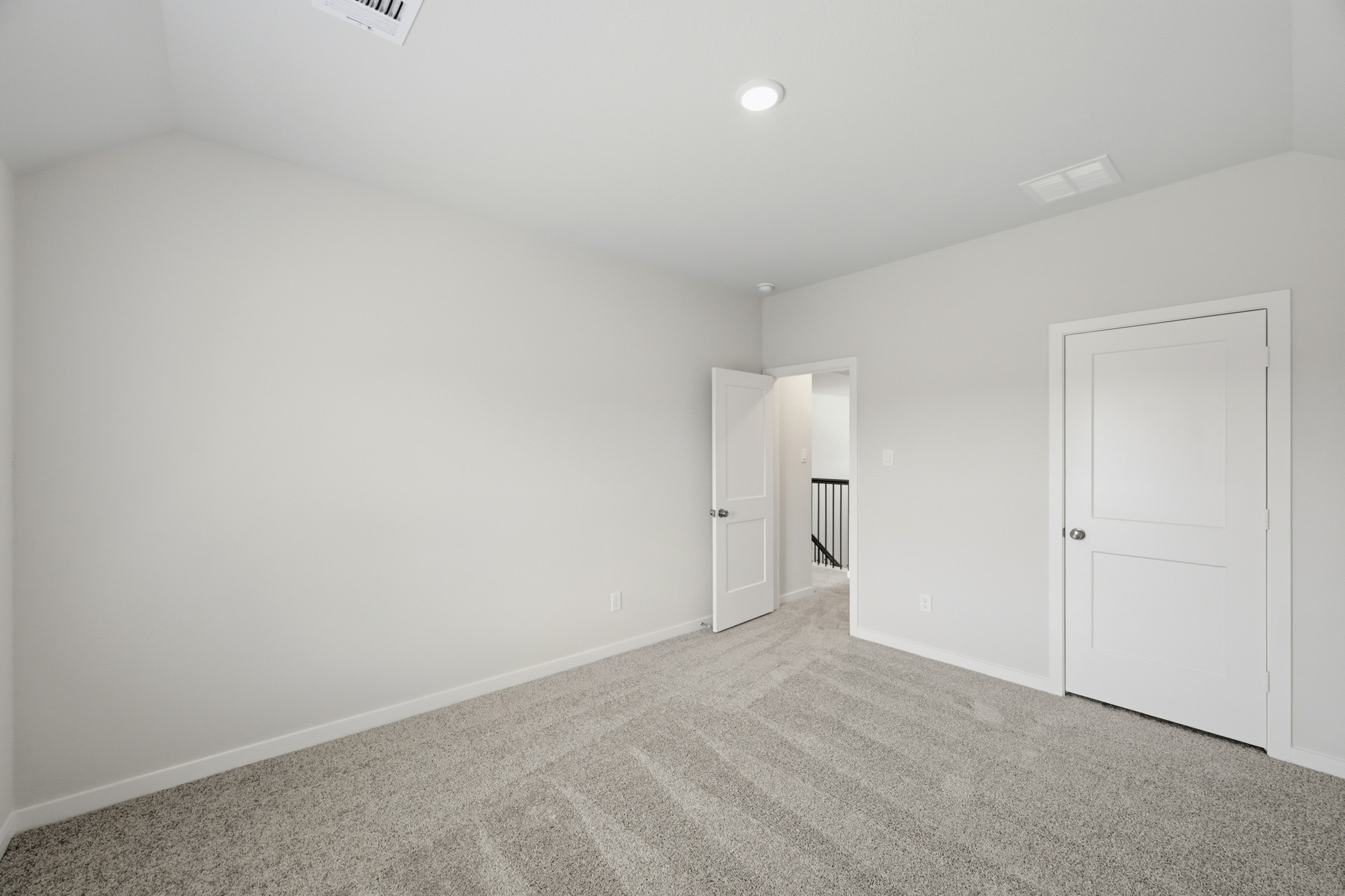 A hallway with white doors.