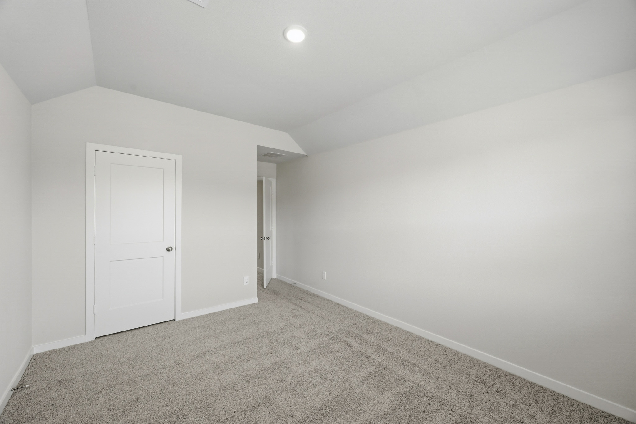 A hallway with white doors.