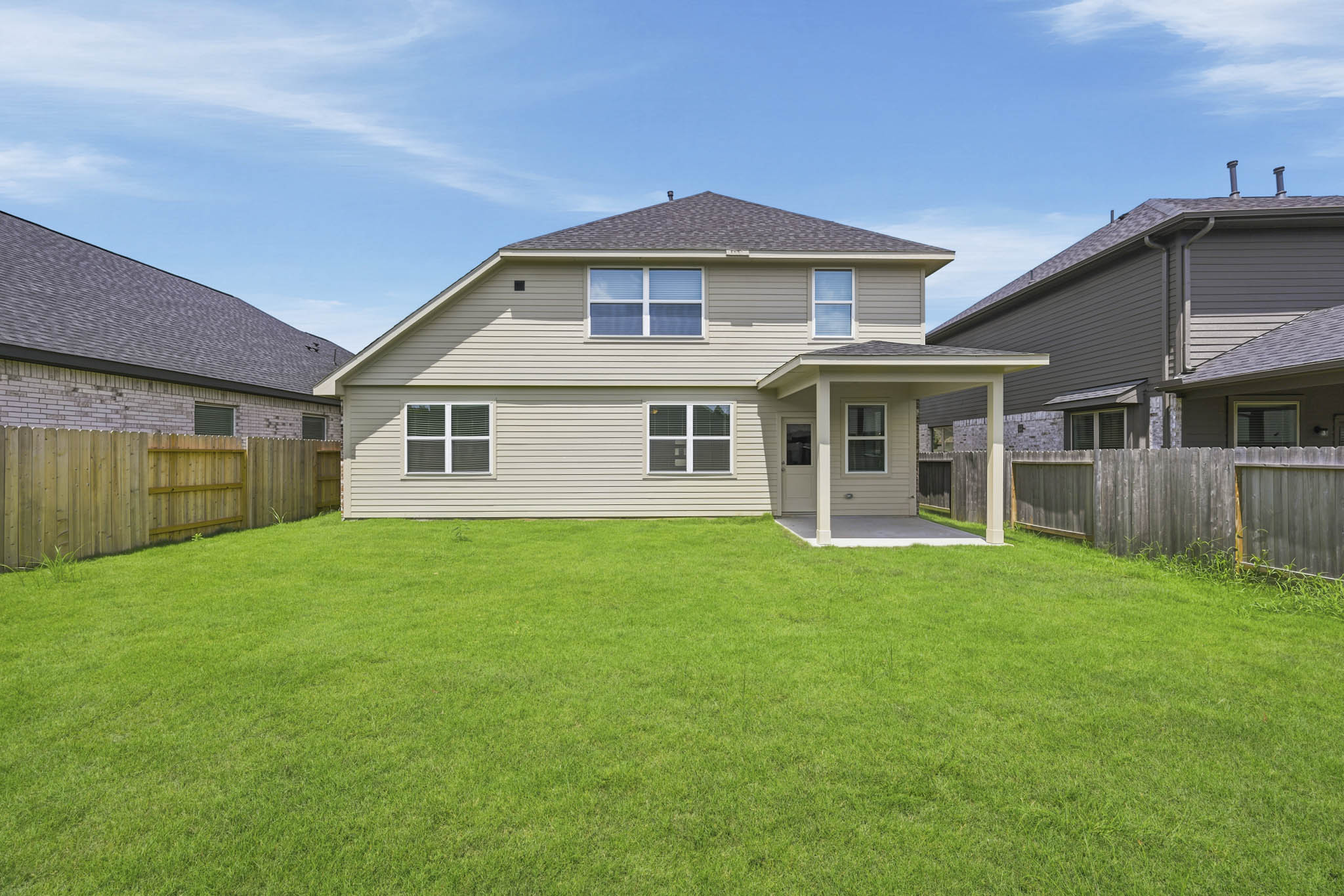 A house with a fence and grass.