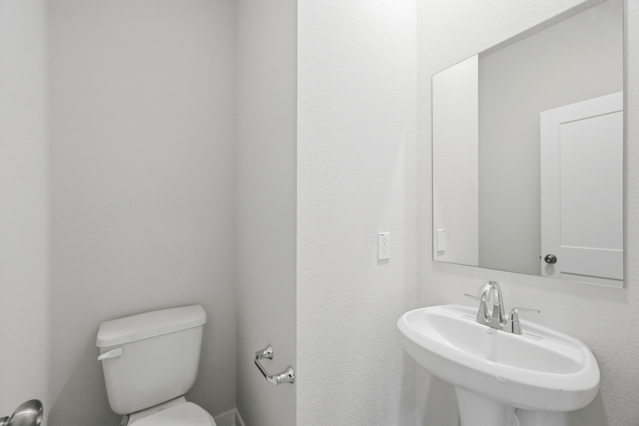 A bathroom with a sink and toilet.