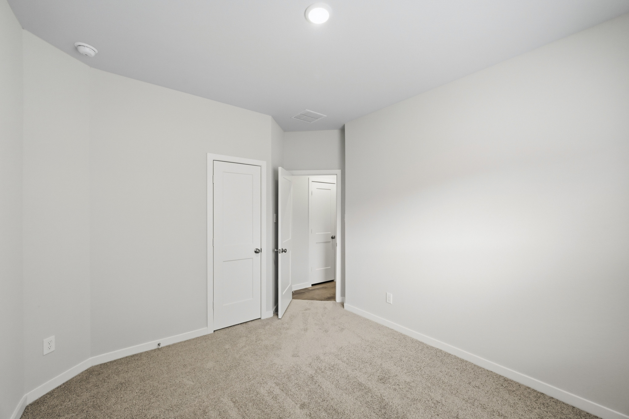 A hallway with white walls.