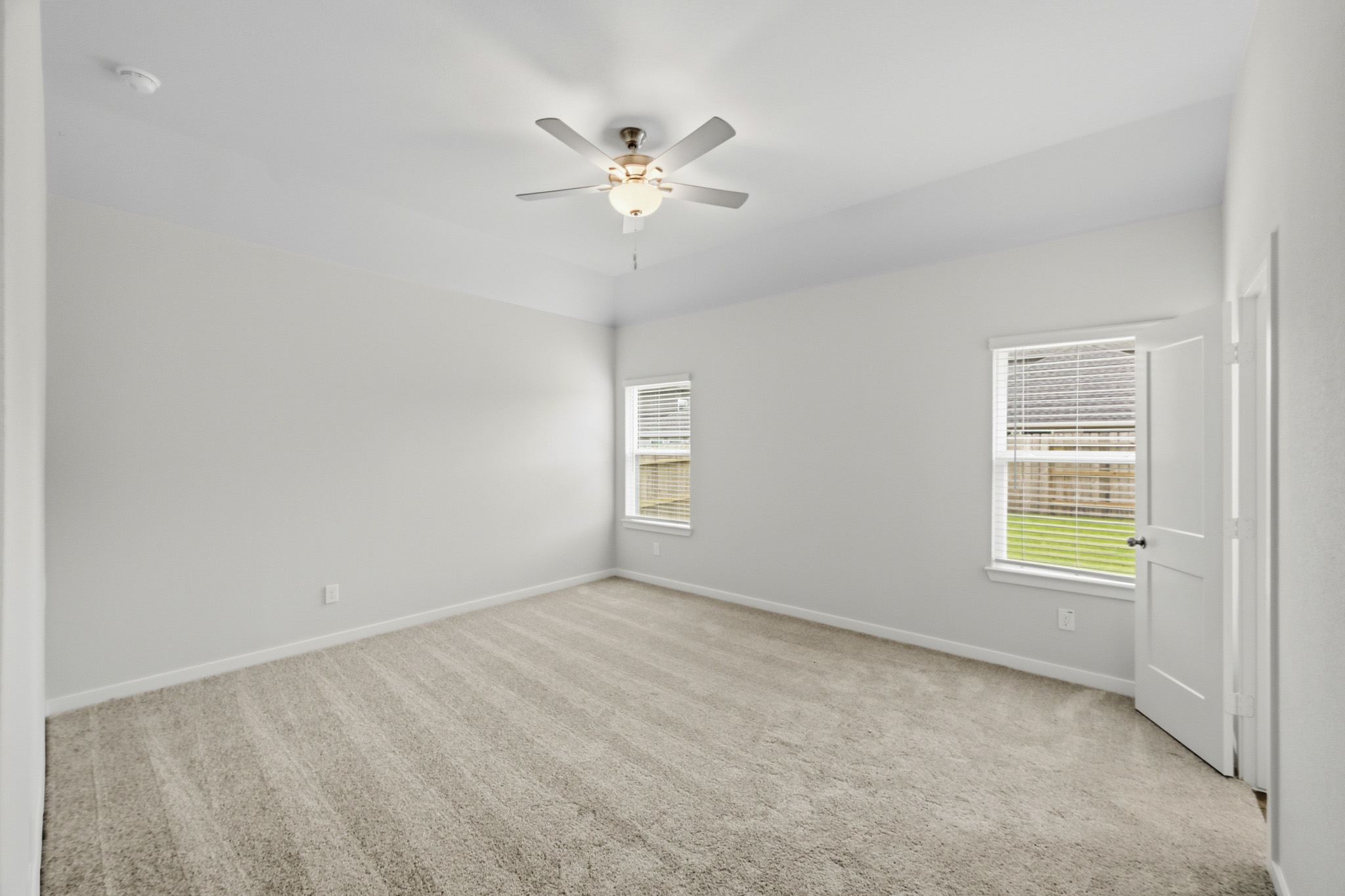 A room with a ceiling fan and a ceiling fan.