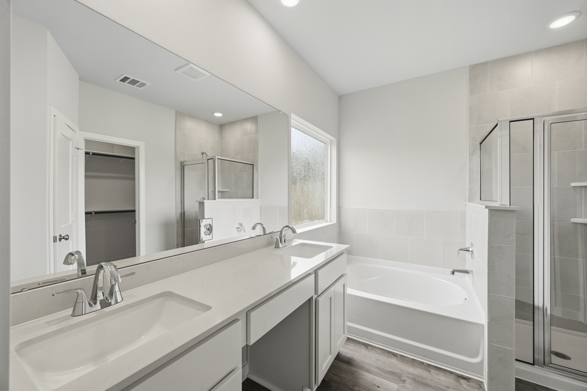 A bathroom with a tub sink and a shower.