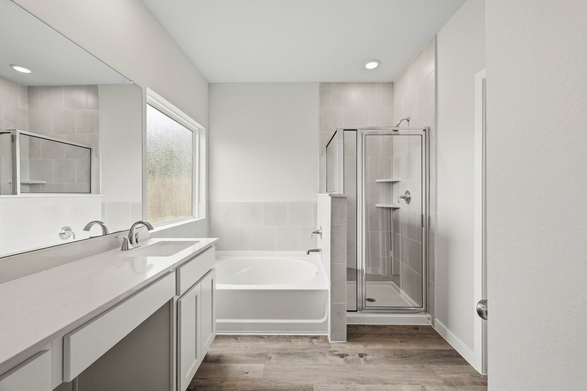 A bathroom with a tub and sink.