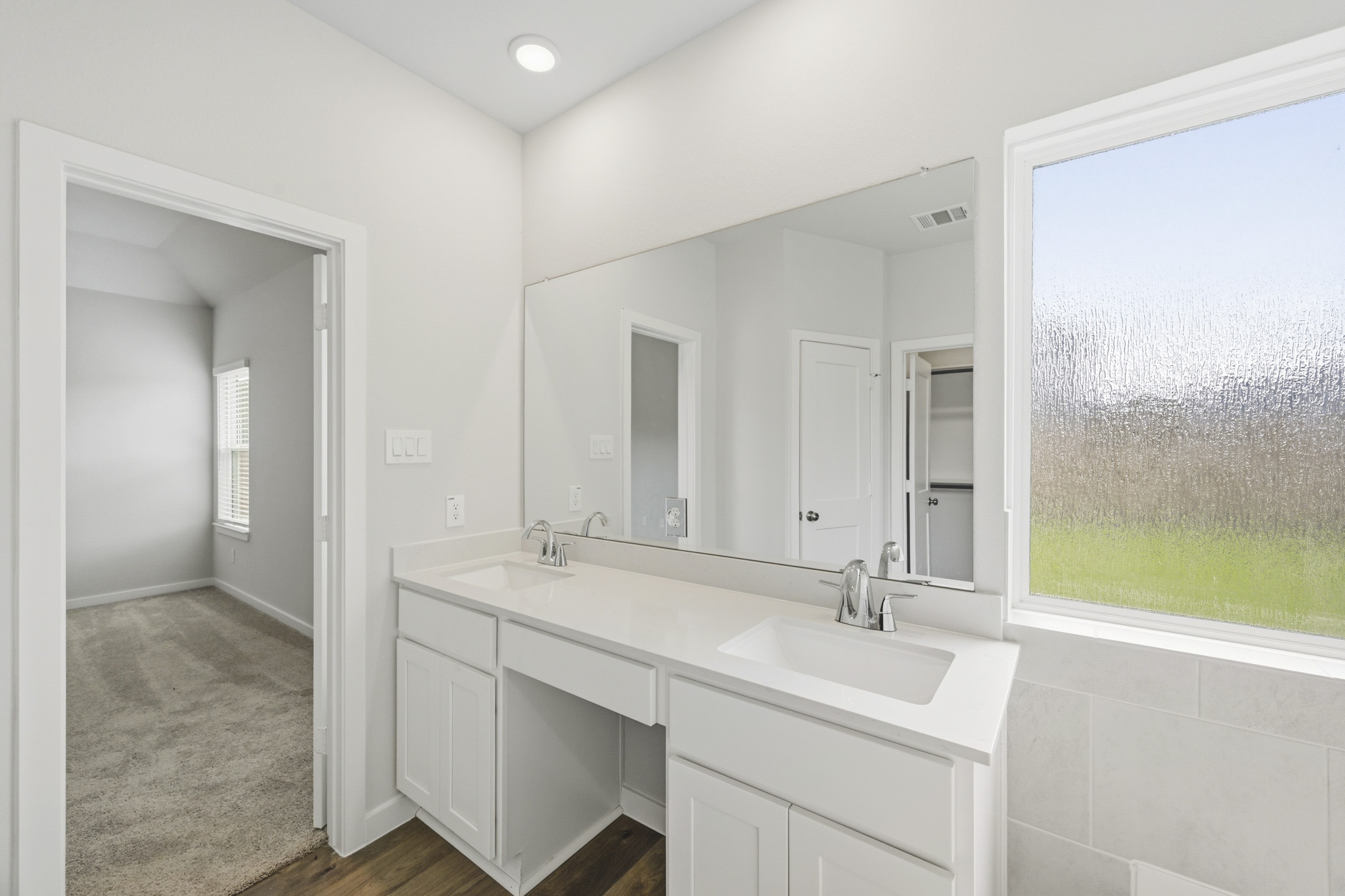 A bathroom with a large mirror.