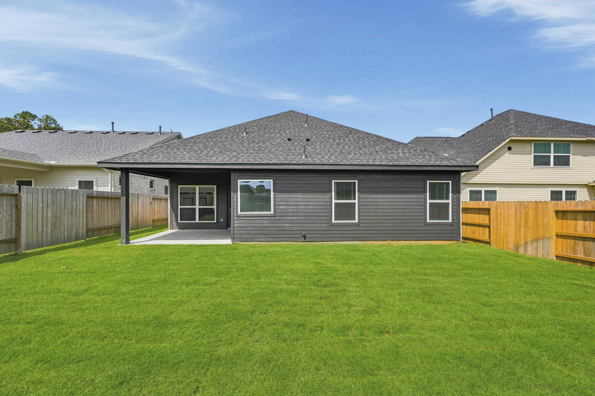 A house with a fence and grass.
