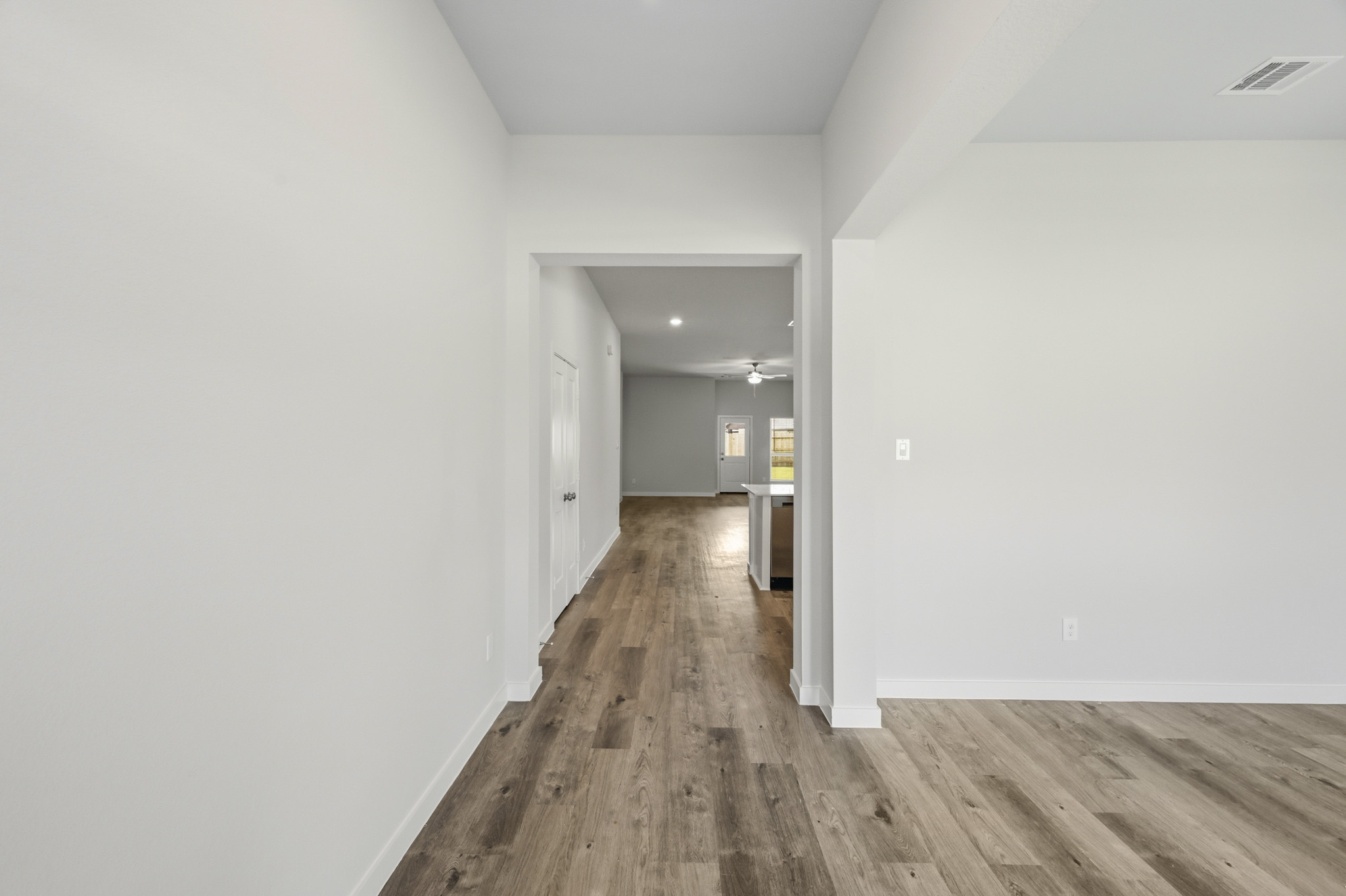 A hallway with white walls.