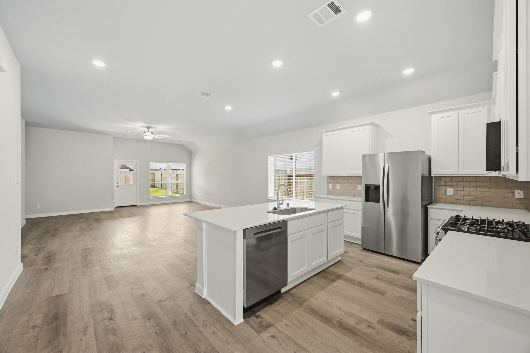 A kitchen with white cabinets.