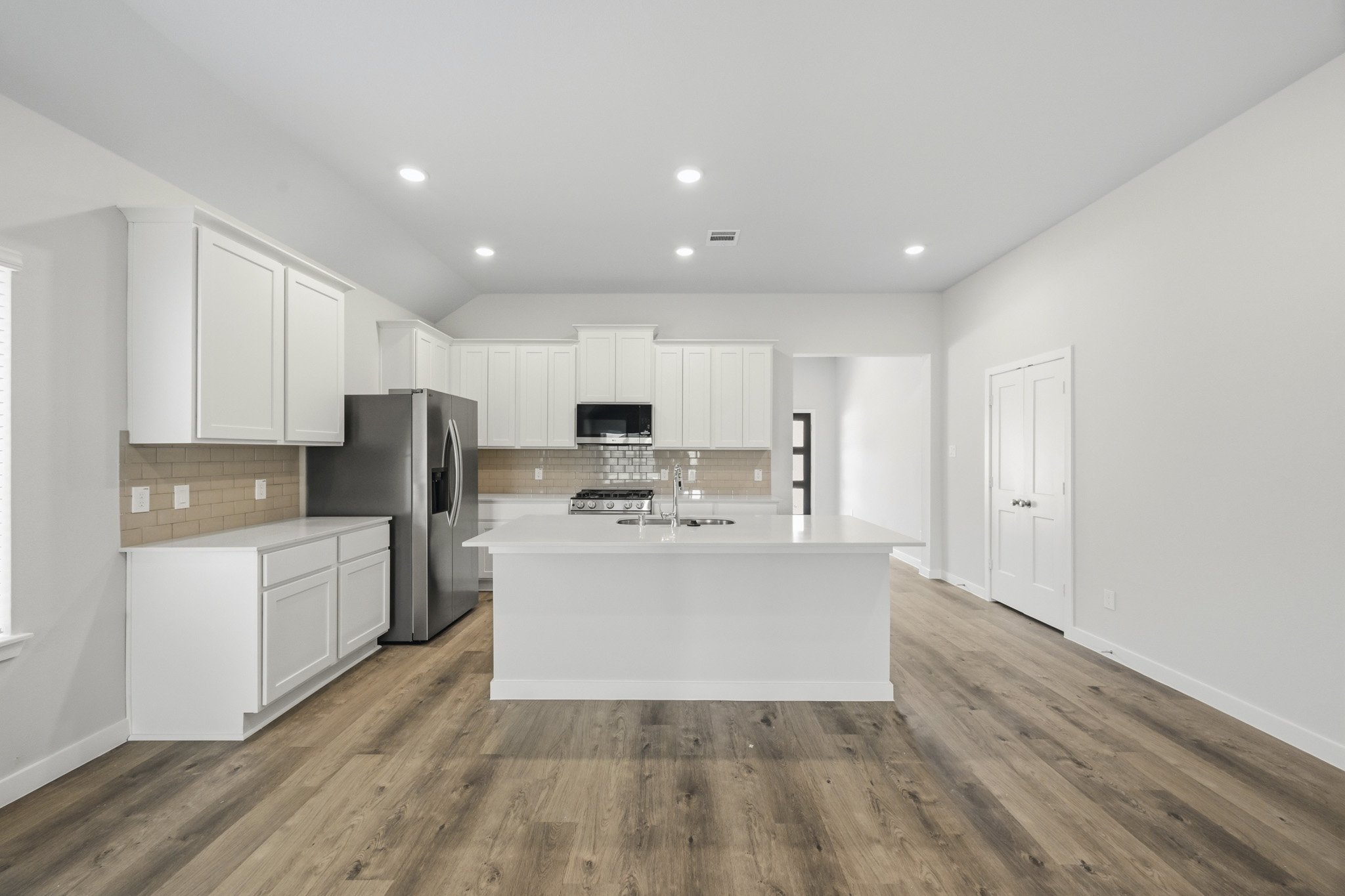 A kitchen with white cabinets.