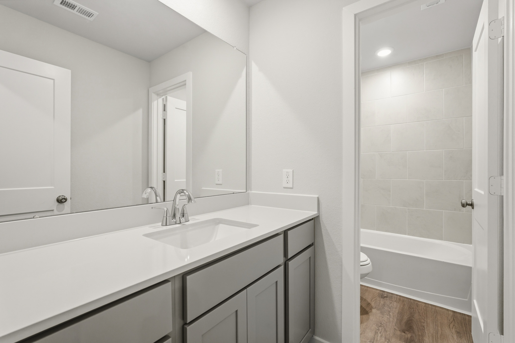 A bathroom with a sink and a bathtub.