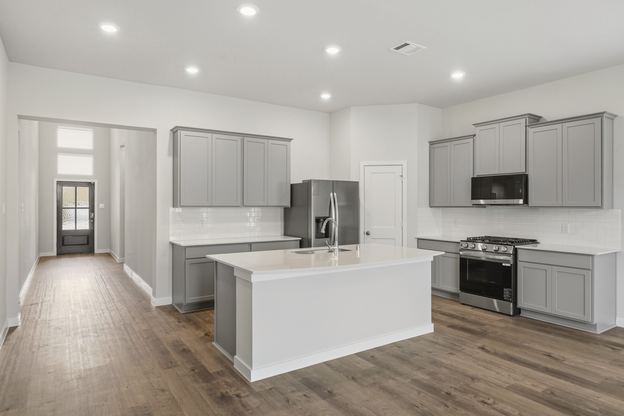 A kitchen with white cabinets.