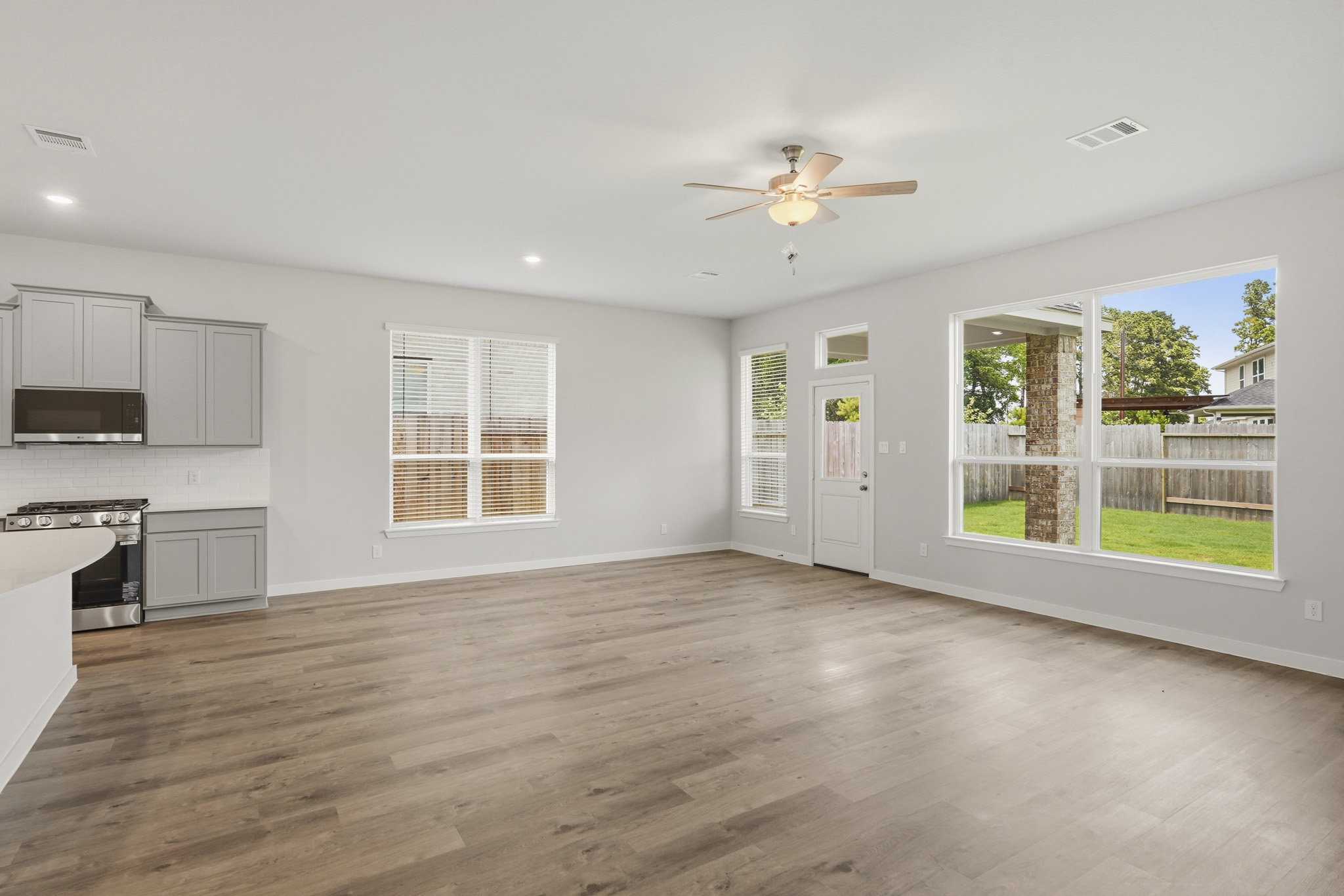 A large kitchen with a wood floor.