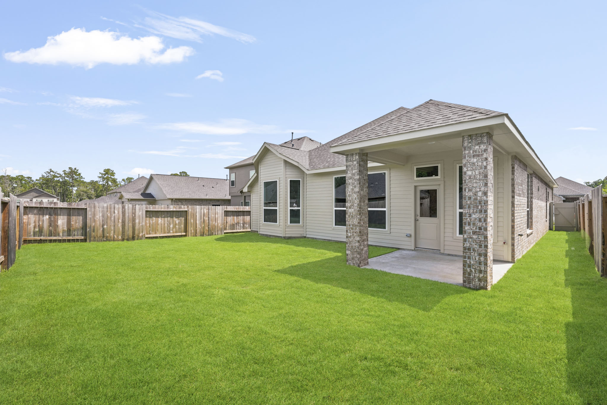 A house with a fence and grass.