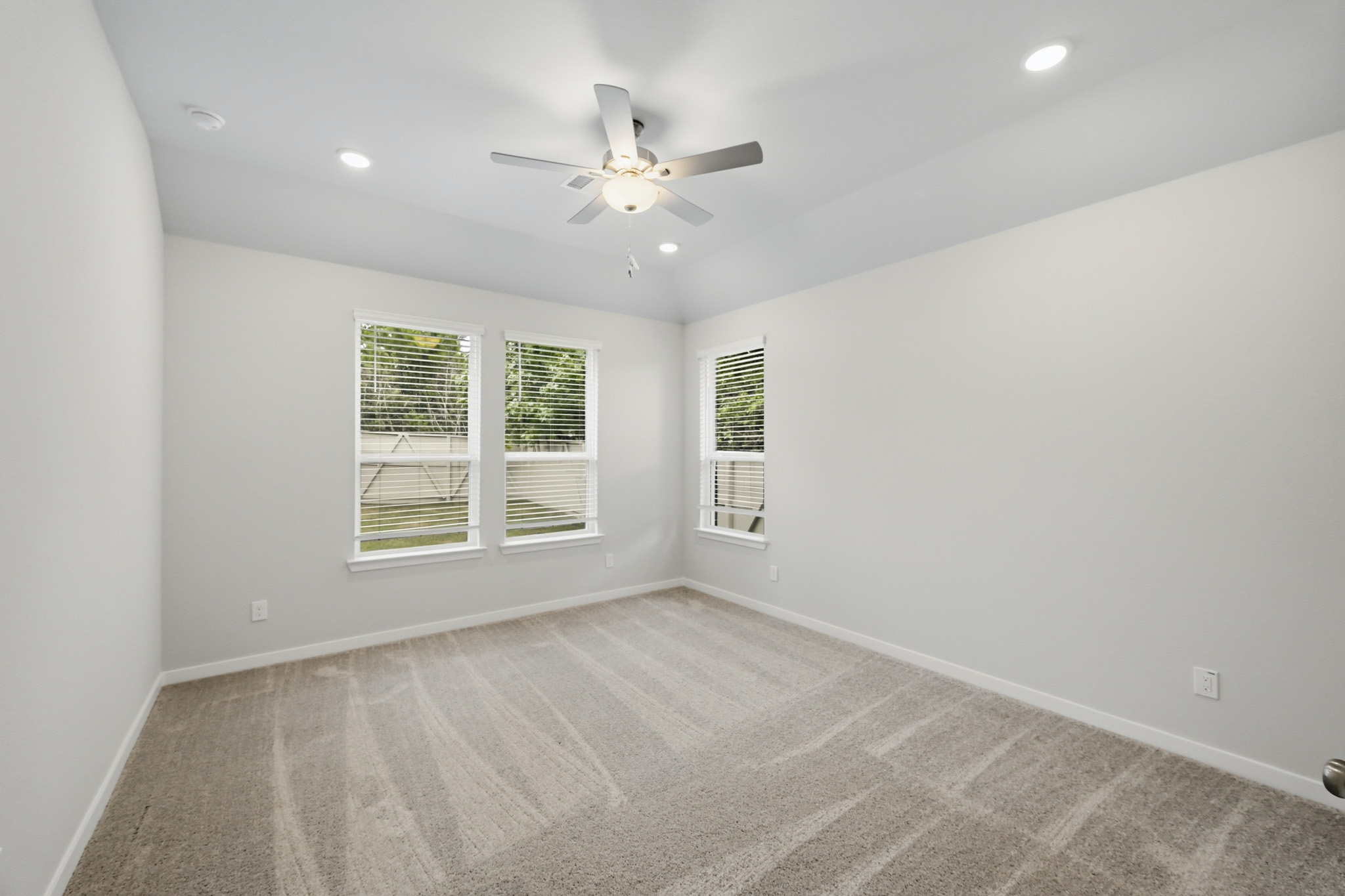 A room with a ceiling fan and a ceiling fan.
