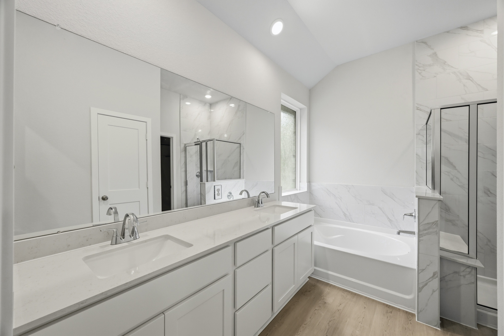 A bathroom with a large mirror.
