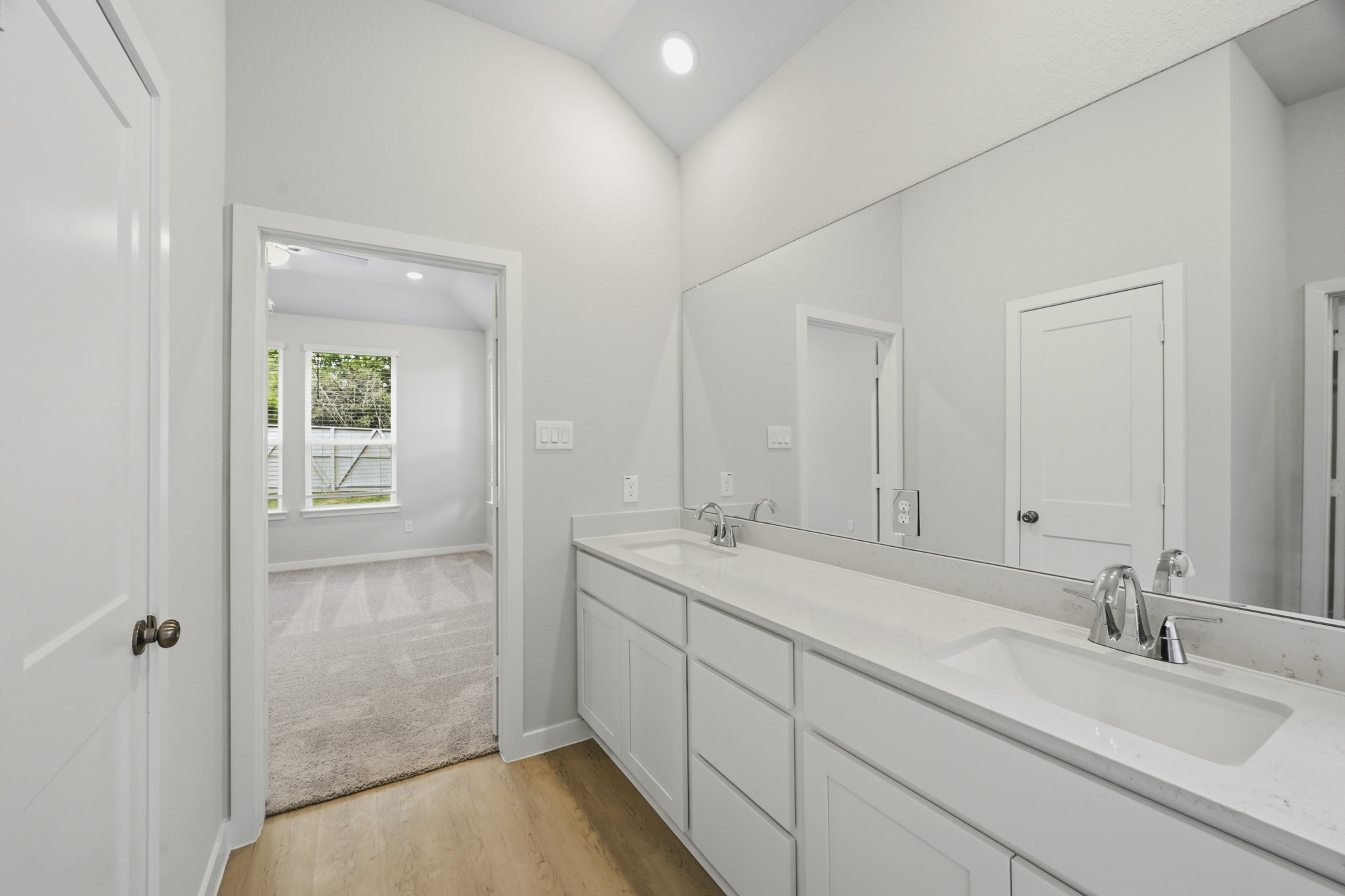 A bathroom with a large mirror.