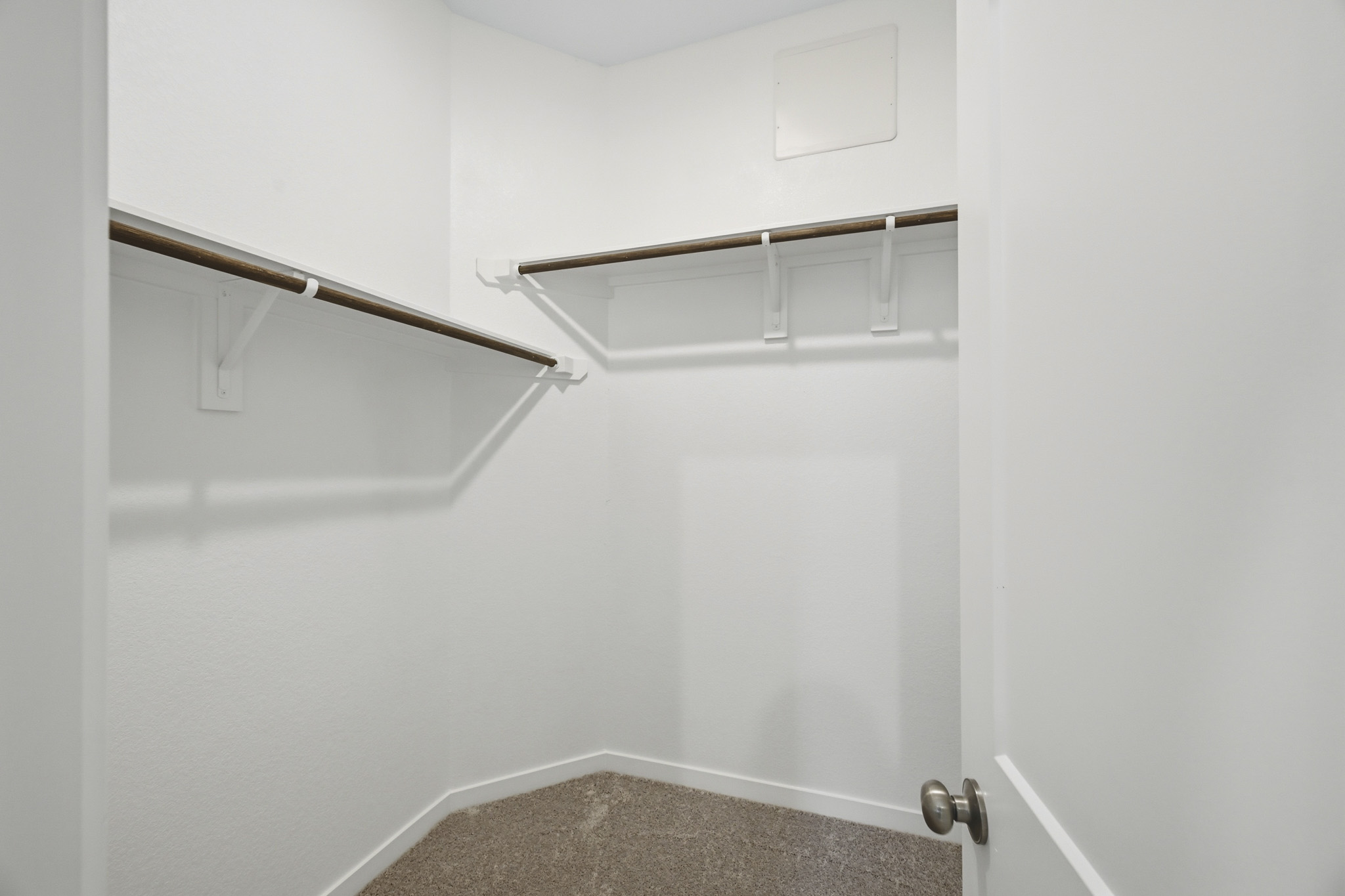A white door with a metal bar.