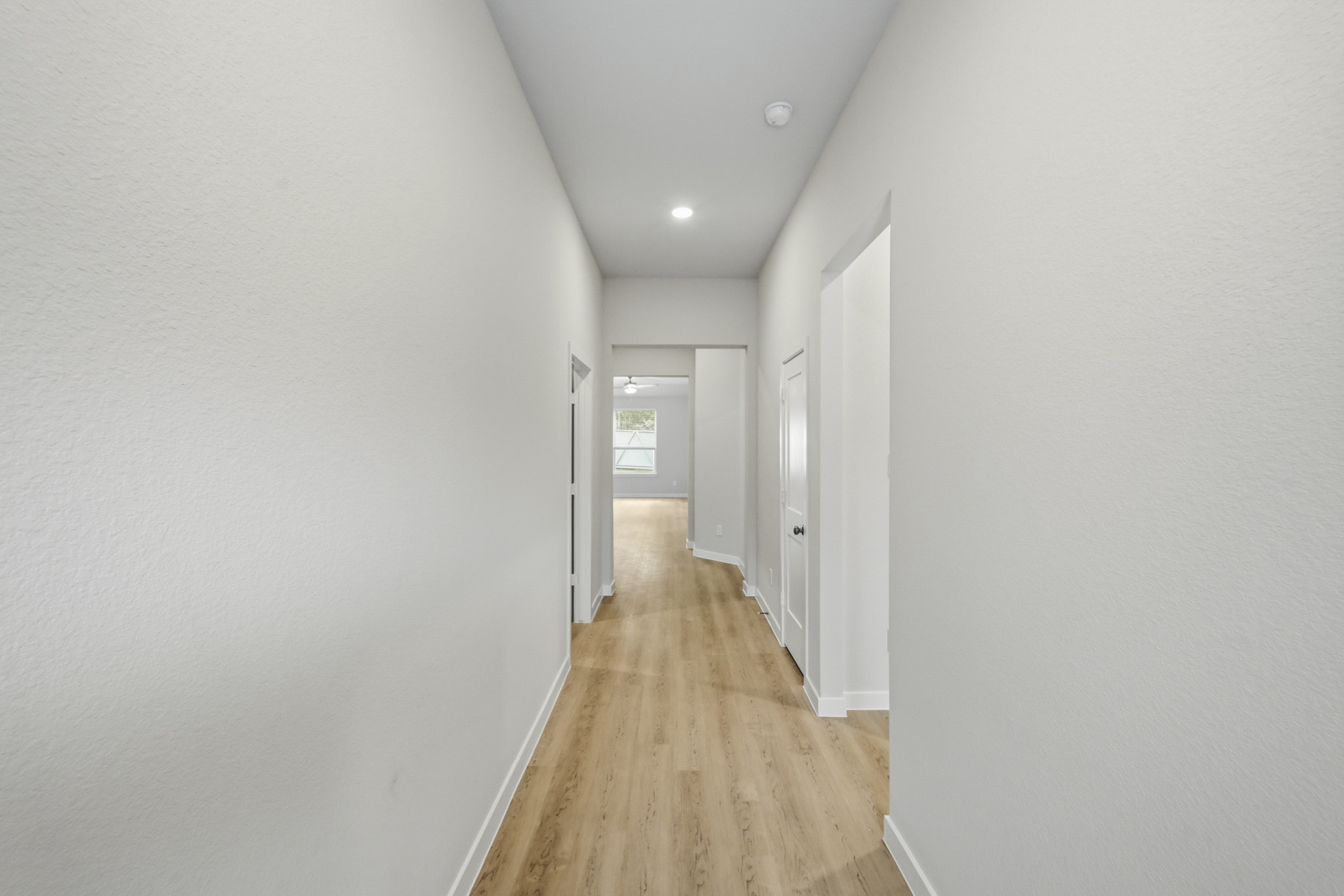 A hallway with white walls.