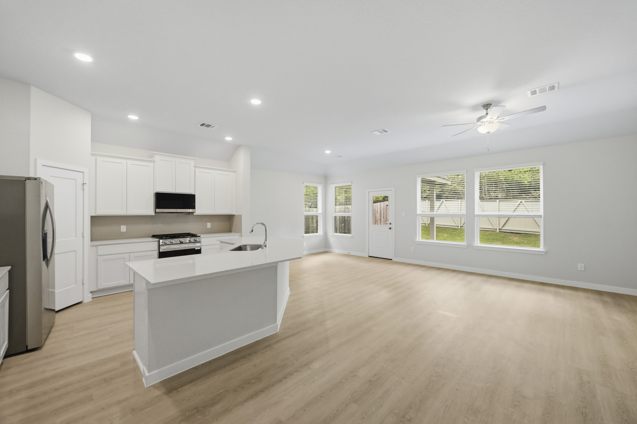 A kitchen with white cabinets.