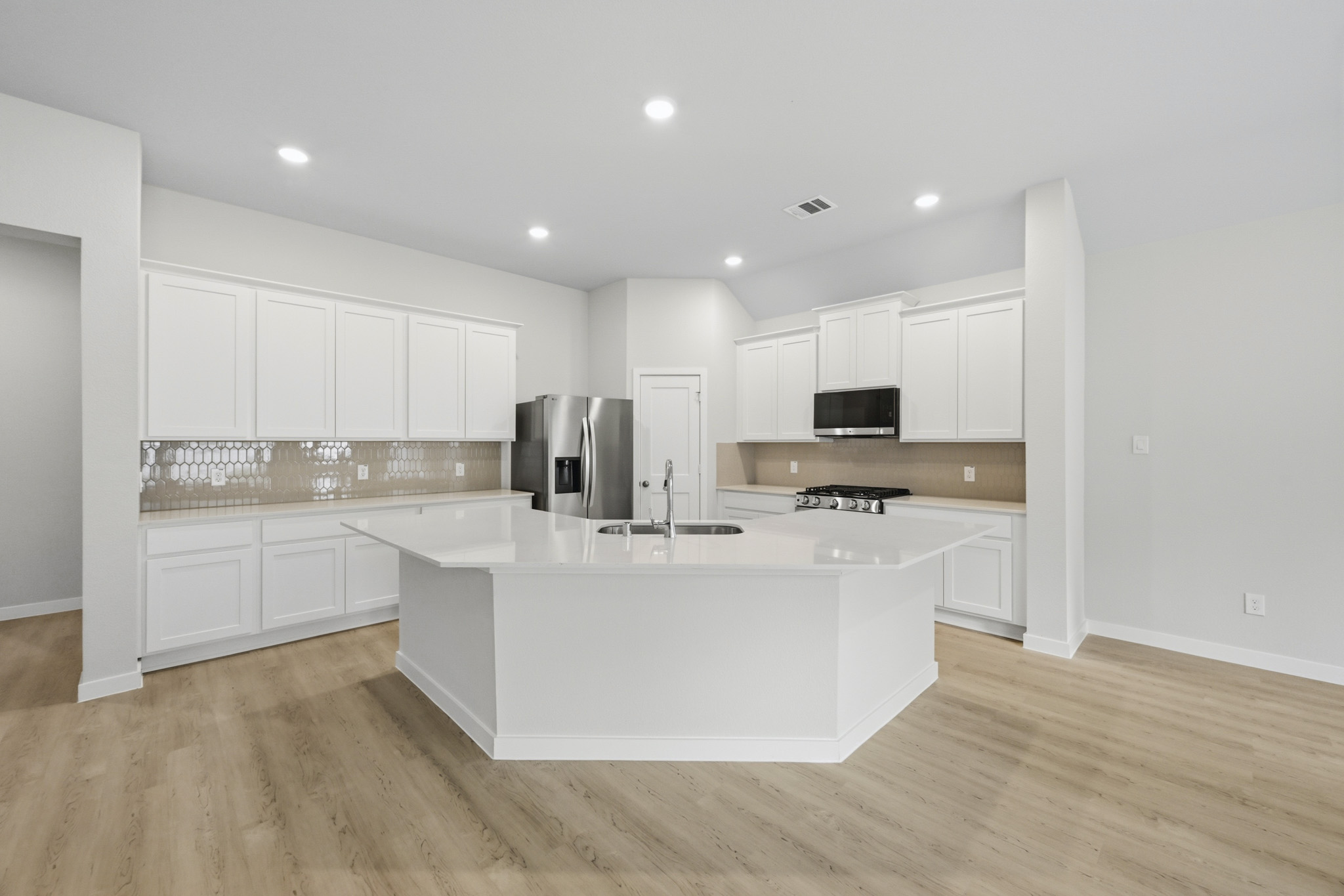 A kitchen with white cabinets.