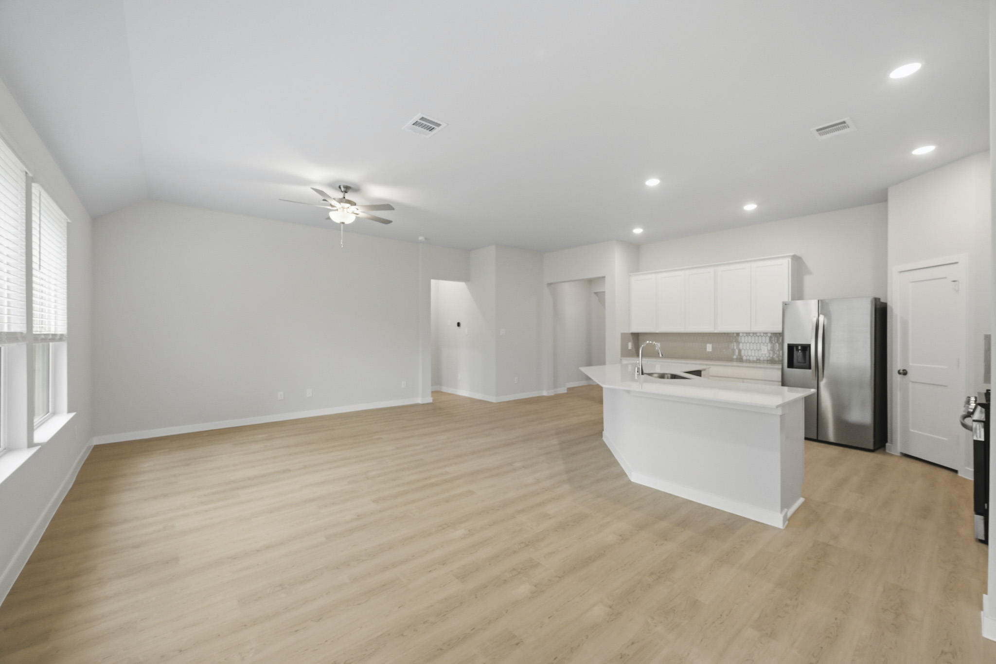 A large kitchen with white cabinets.