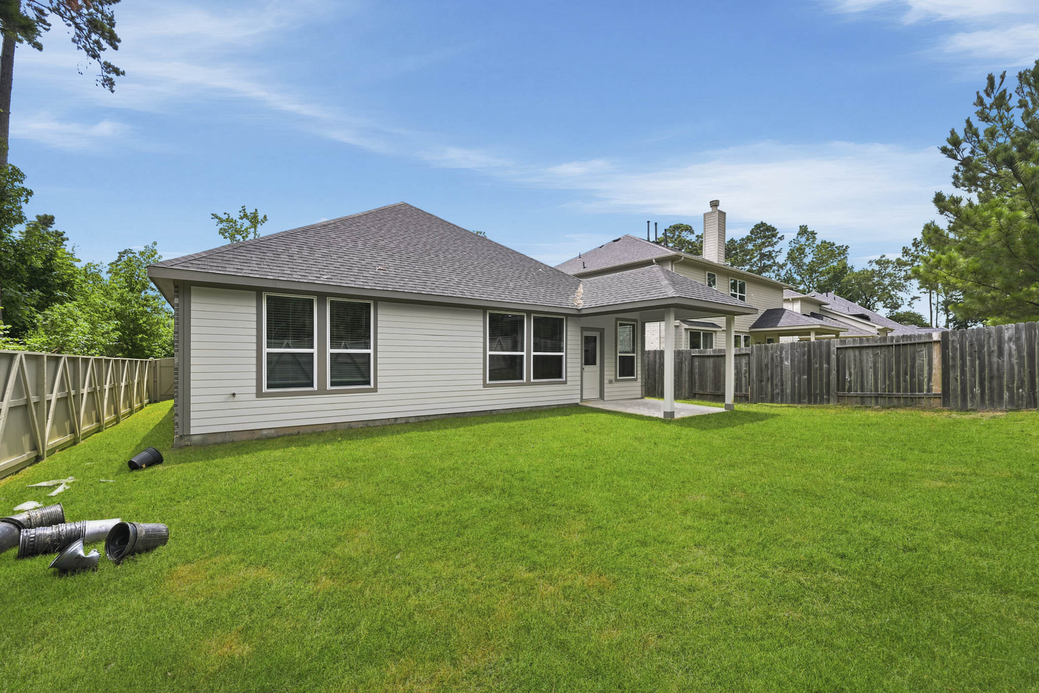 A house with a fence and grass.