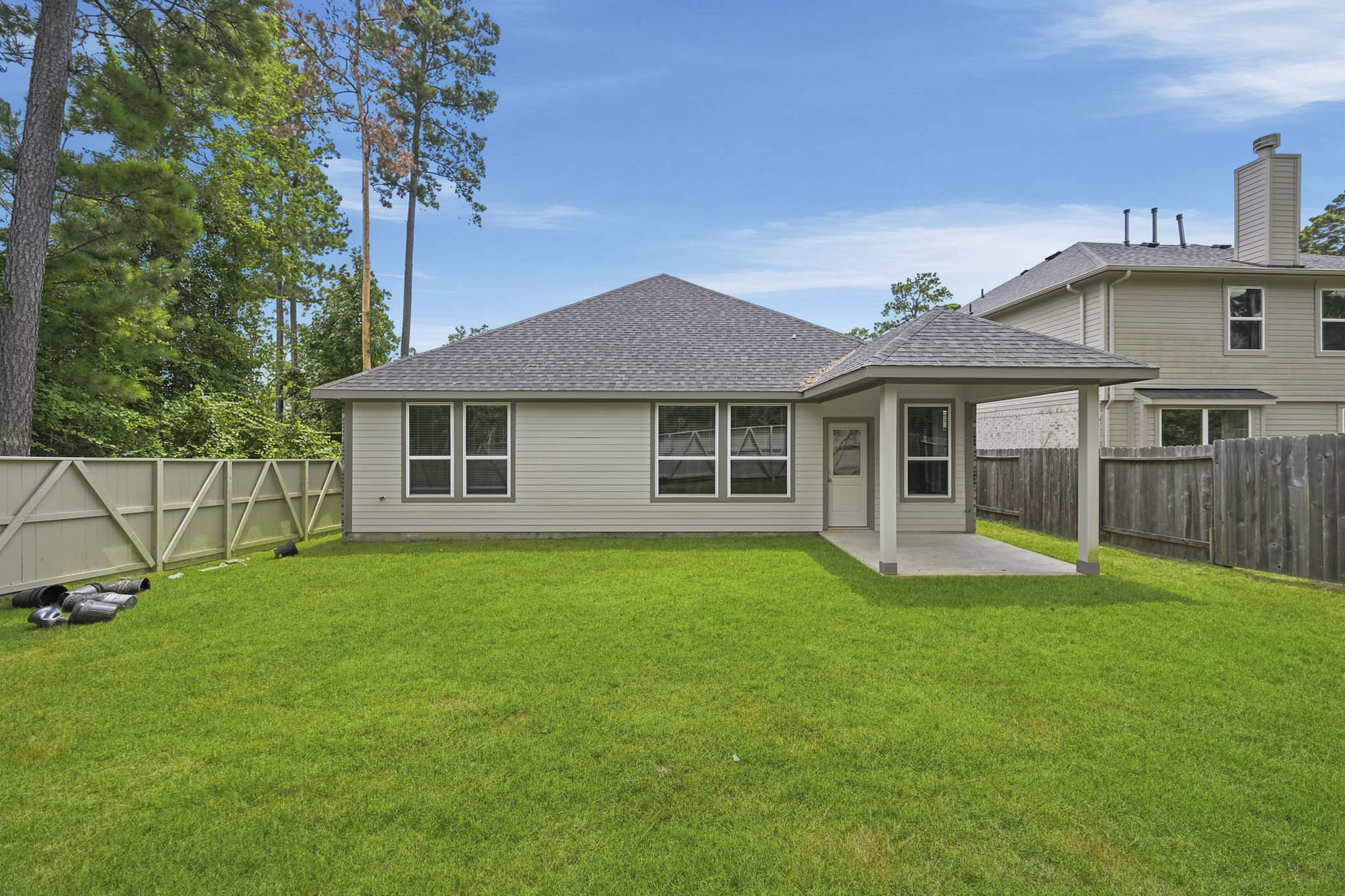 A house with a fence and trees.