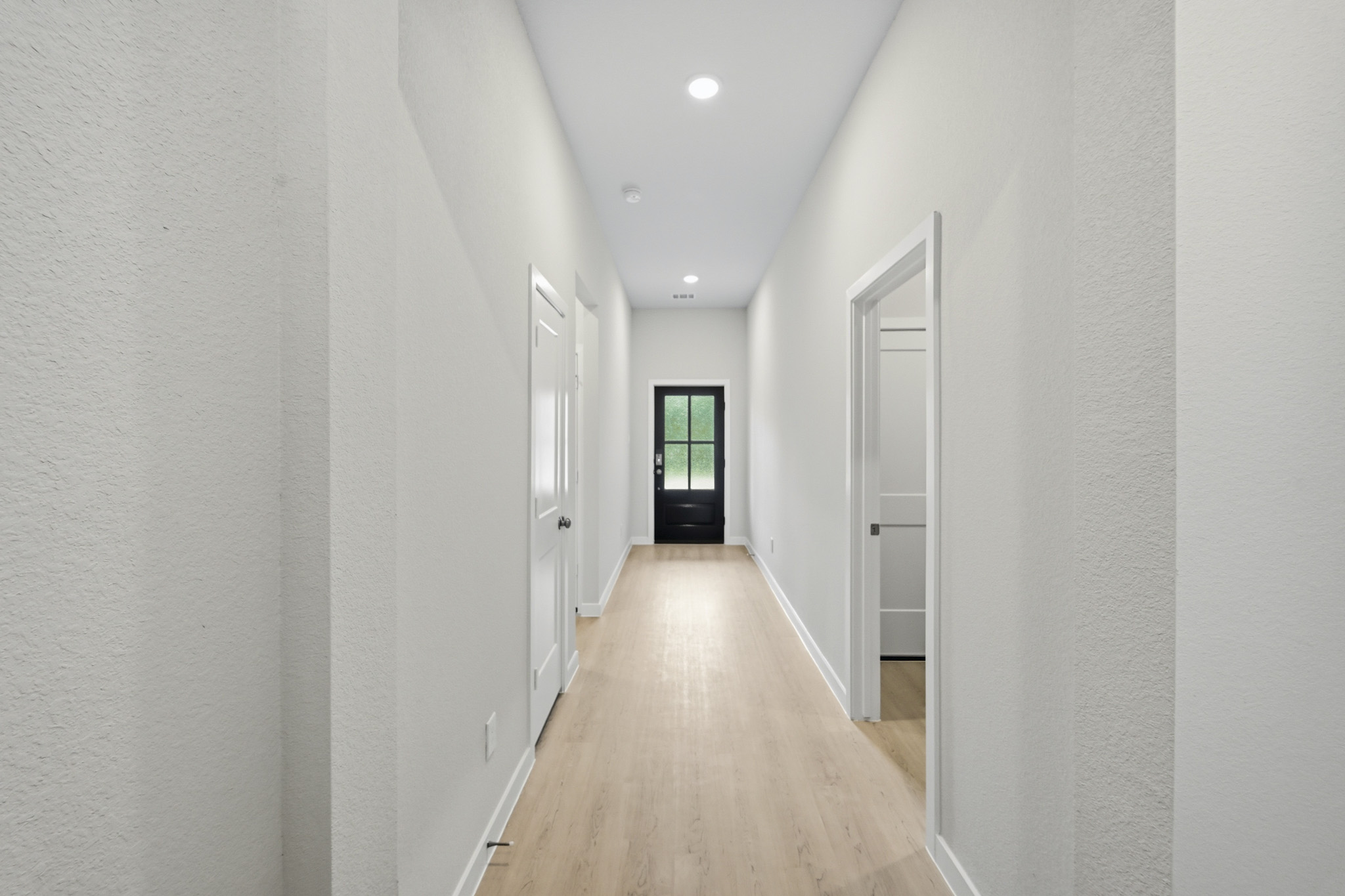 A long hallway with white walls.